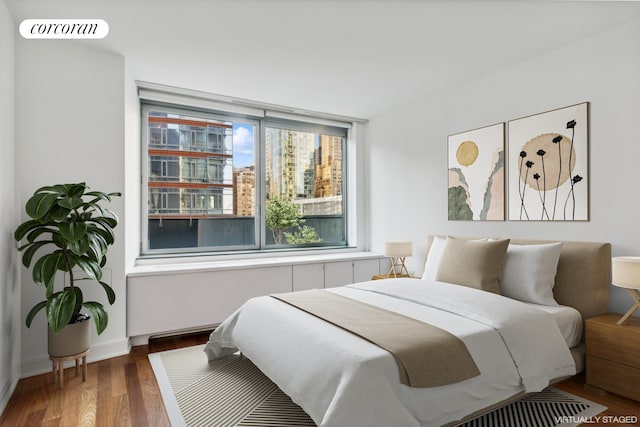 bedroom featuring visible vents and wood finished floors