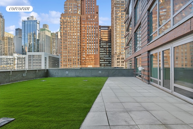 view of property's community with a view of city, a patio area, visible vents, and a lawn