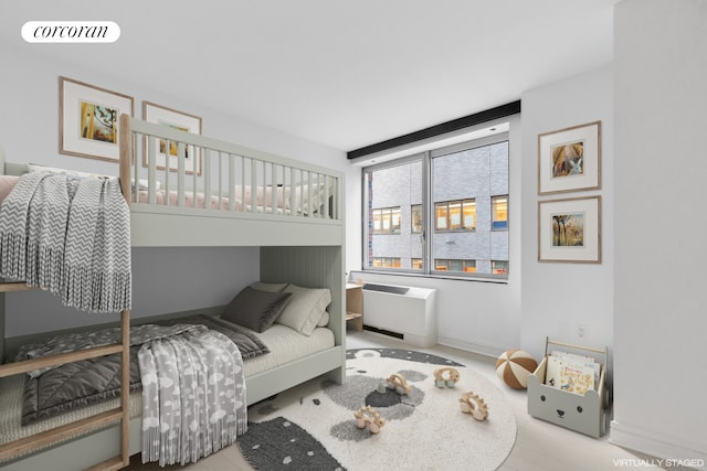 bedroom featuring radiator heating unit, visible vents, and baseboards