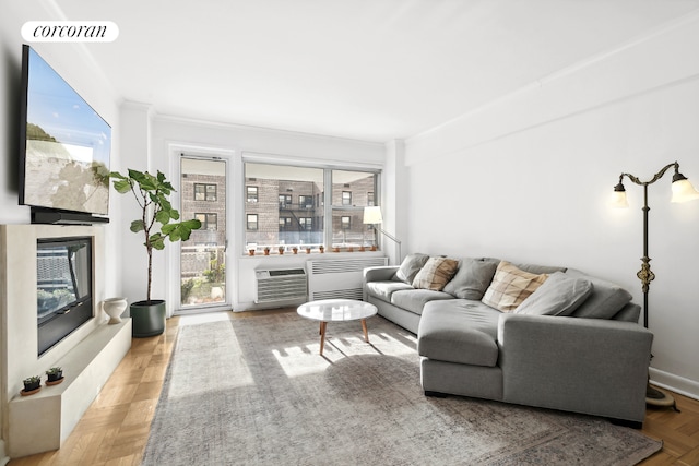 living room featuring parquet flooring and a wall mounted air conditioner