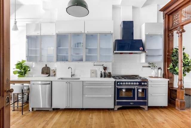 kitchen with extractor fan, light countertops, stainless steel dishwasher, double oven range, and a sink