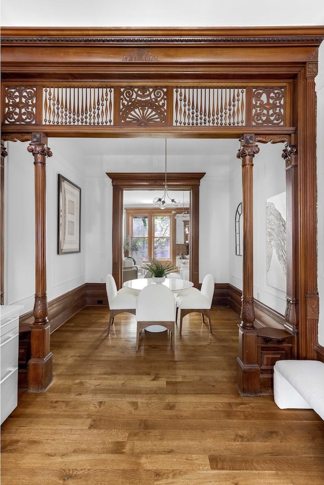 dining area with baseboards and wood finished floors