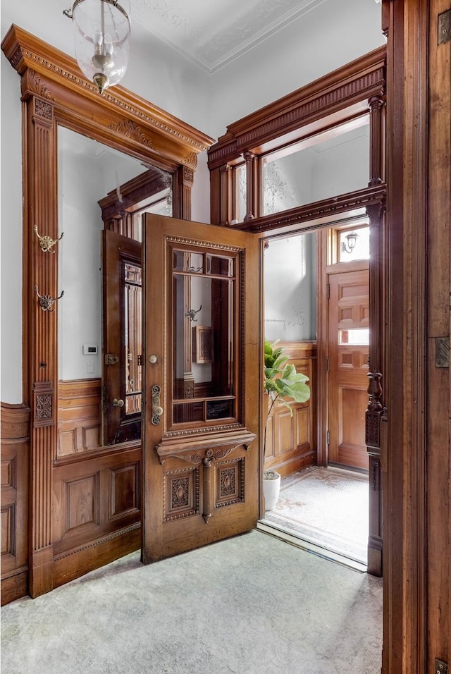 mudroom featuring carpet flooring and wainscoting