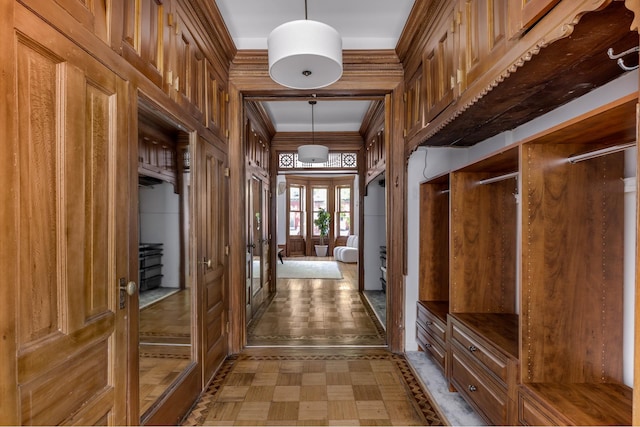 mudroom with french doors, tile patterned floors, and crown molding