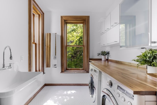 laundry area with washing machine and dryer, laundry area, and baseboards