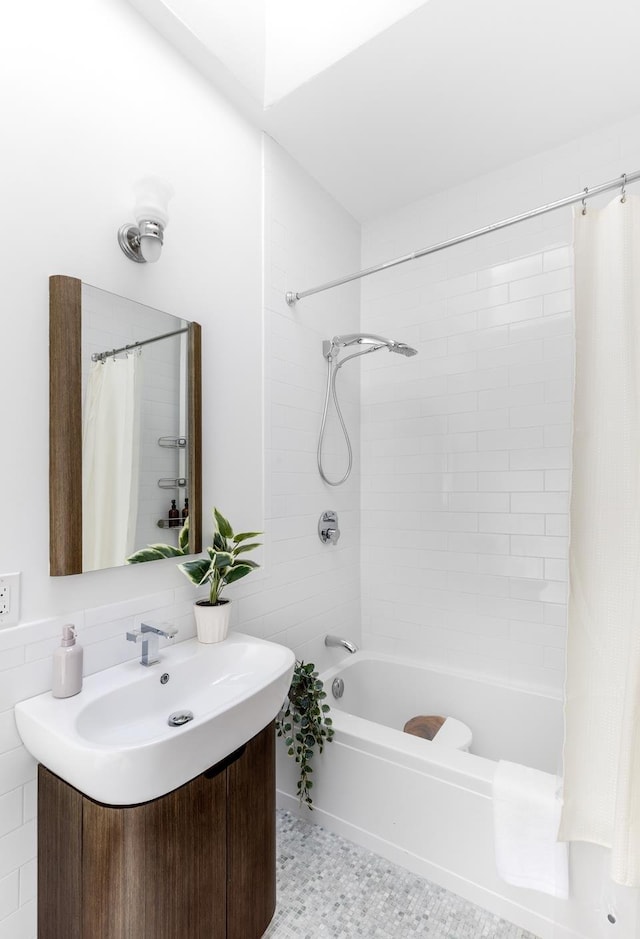 bathroom featuring vanity and shower / bathtub combination with curtain