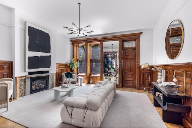 living room with a glass covered fireplace and an inviting chandelier