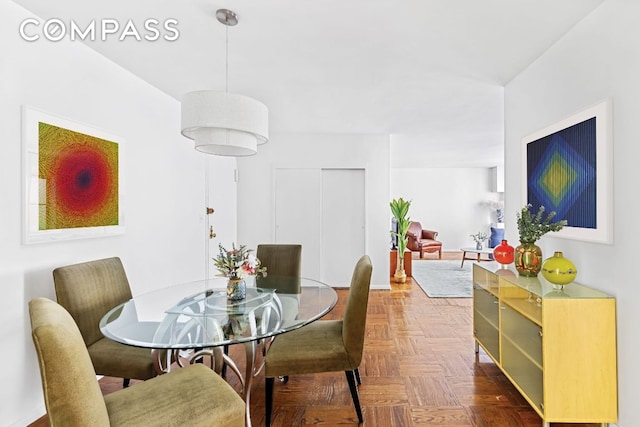 dining area with dark parquet flooring