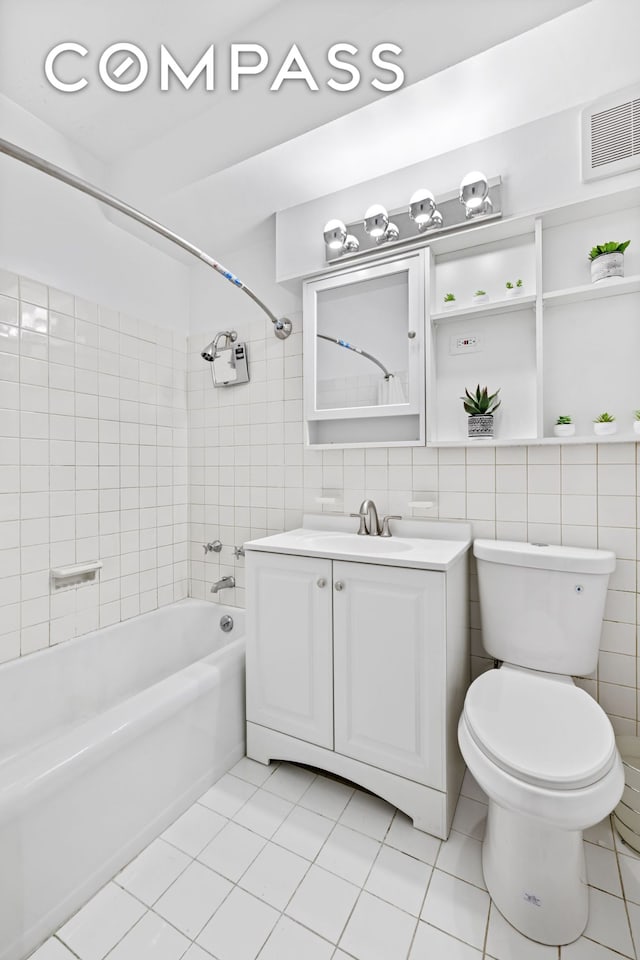 12 Beekman Pl Unit 9D, New York City, NY 10022 - full bath with vanity, shower / tub combination, toilet, tile patterned floors, and tile walls