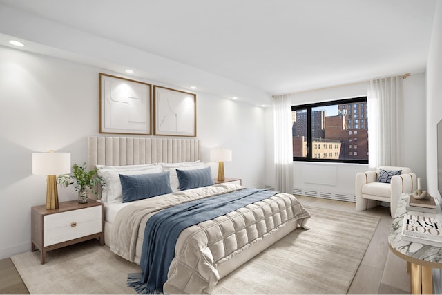 bedroom with light wood-style floors and recessed lighting