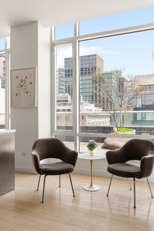 sitting room with light wood-type flooring and a city view