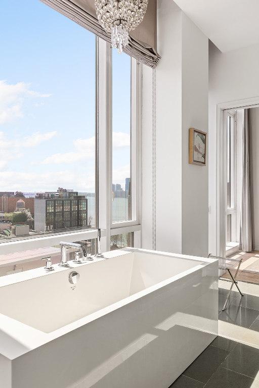 bathroom with a chandelier