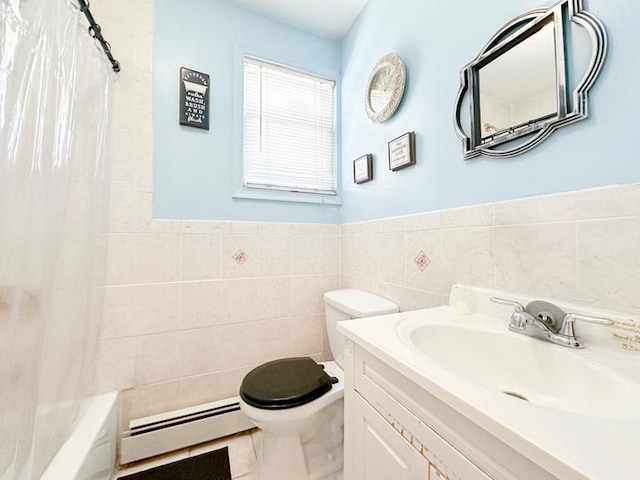 full bath with wainscoting, toilet, a baseboard radiator, vanity, and tile walls