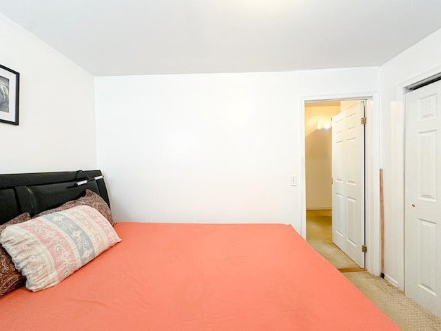 bedroom featuring light colored carpet