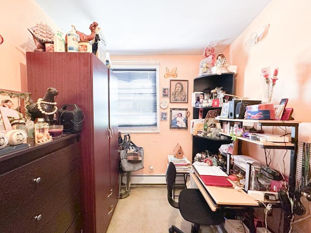 carpeted home office with a baseboard radiator and baseboards