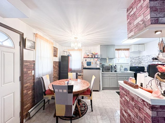 49 Steuben St, New York City, NY 10304 - dining area featuring a baseboard radiator and a chandelier