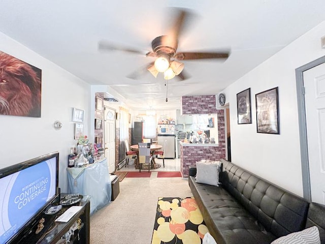 living area with carpet floors and ceiling fan