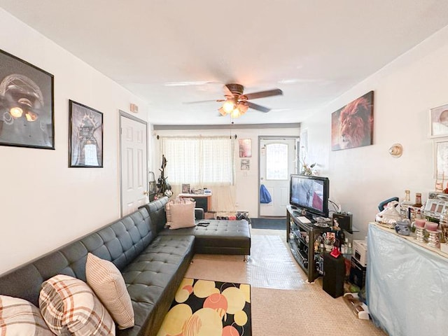 living room featuring light colored carpet and ceiling fan