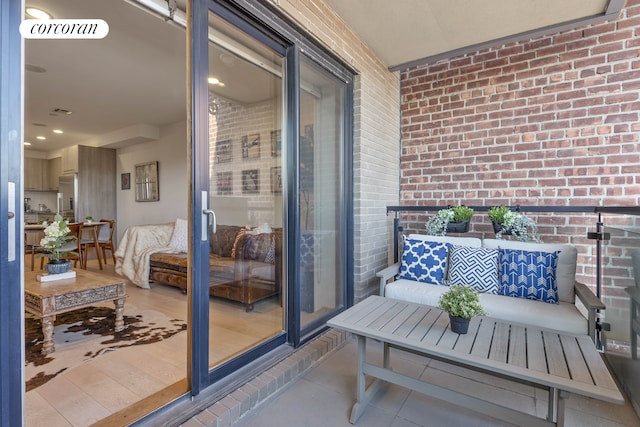 balcony with an outdoor living space and visible vents