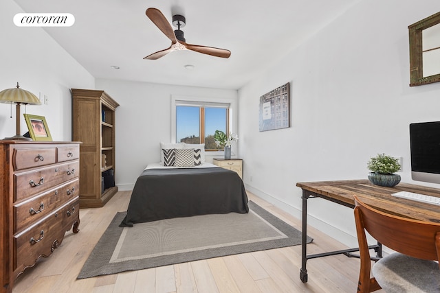 bedroom with baseboards, a ceiling fan, light wood finished floors, and visible vents