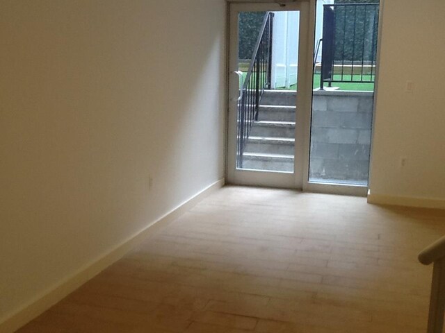 spare room featuring light hardwood / wood-style flooring