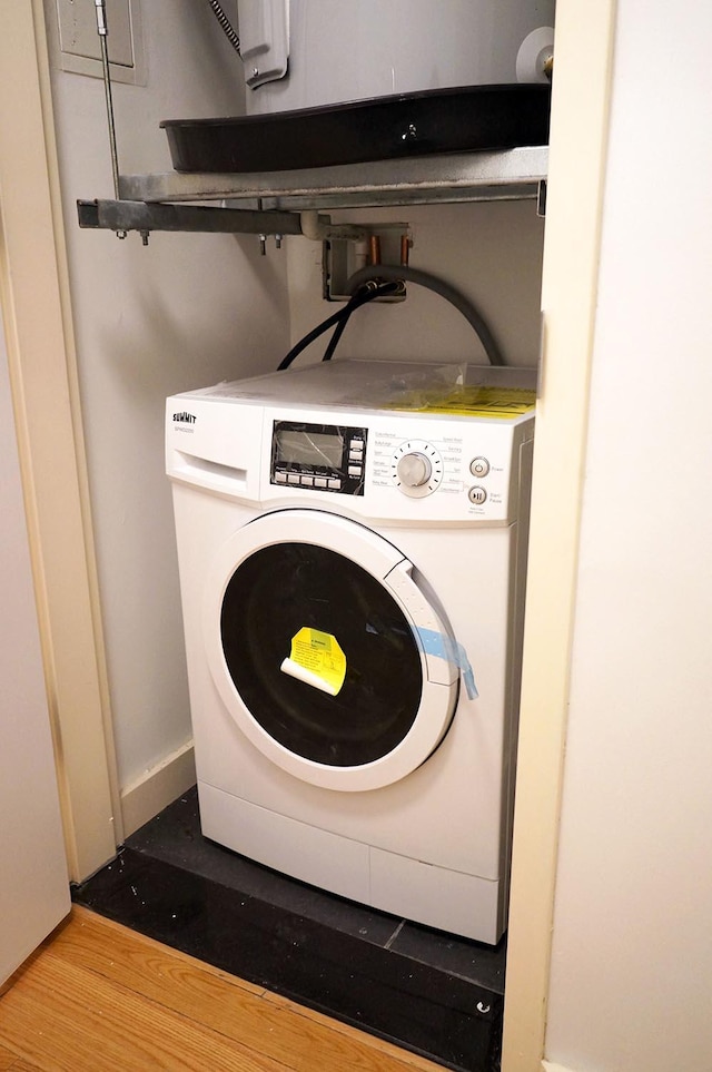 362 W 127th St Unit 1-A, New York City, NY 10027 - laundry area with washer / clothes dryer, wood finished floors, and baseboards