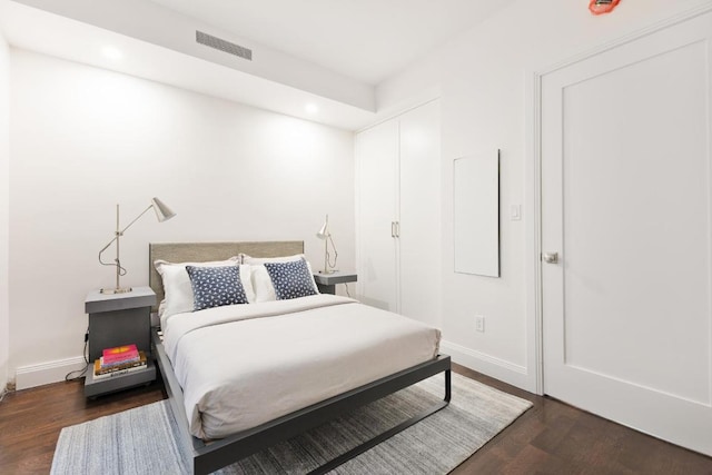 bedroom with dark wood-type flooring