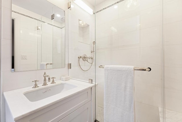 bathroom with walk in shower and vanity