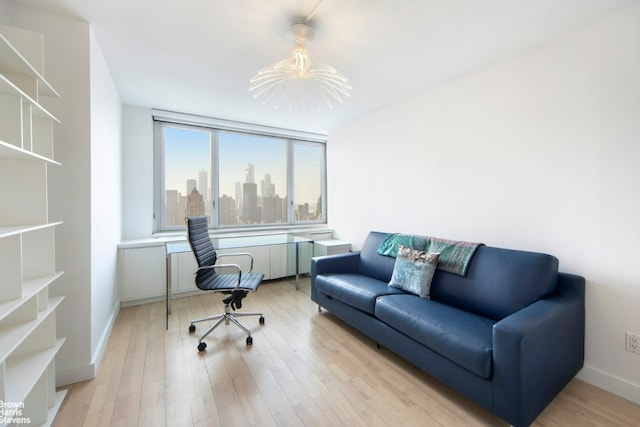 home office featuring a notable chandelier and light hardwood / wood-style floors