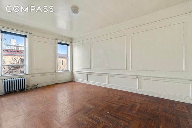 88 Brooklyn Ave Unit D5, New York City, NY 11216 - spare room featuring radiator, a decorative wall, and healthy amount of natural light