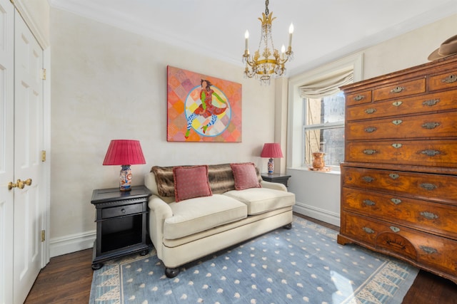 sitting room featuring a notable chandelier, ornamental molding, and dark hardwood / wood-style floors