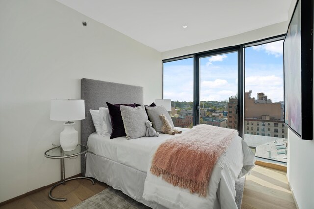 179 20th St Unit 8B, New York City, NY 11232 - bedroom featuring baseboards and wood finished floors