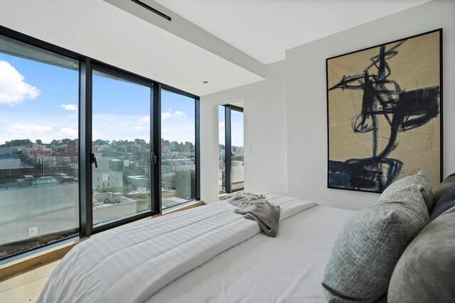 179 20th St Unit 8B, New York City, NY 11232 - bedroom with floor to ceiling windows and a city view