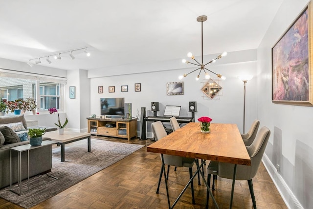 dining room featuring dark parquet floors and rail lighting