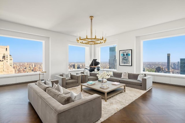 living room with a notable chandelier and dark parquet floors