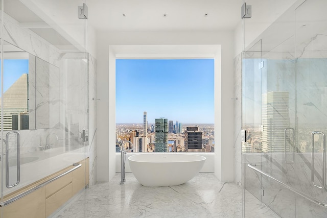bathroom featuring marble tiled floors, a freestanding tub, a city view, and a marble finish shower