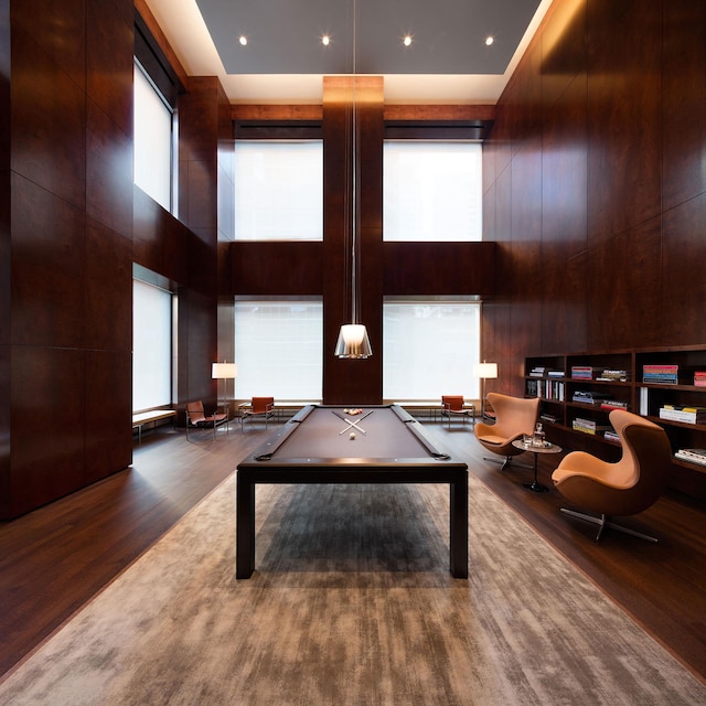 rec room with a high ceiling, wood finished floors, and billiards