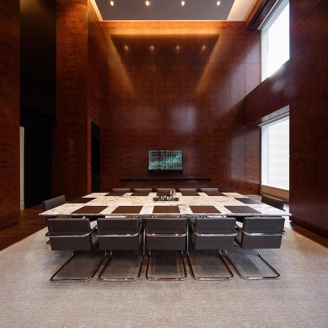 dining space with a towering ceiling and plenty of natural light