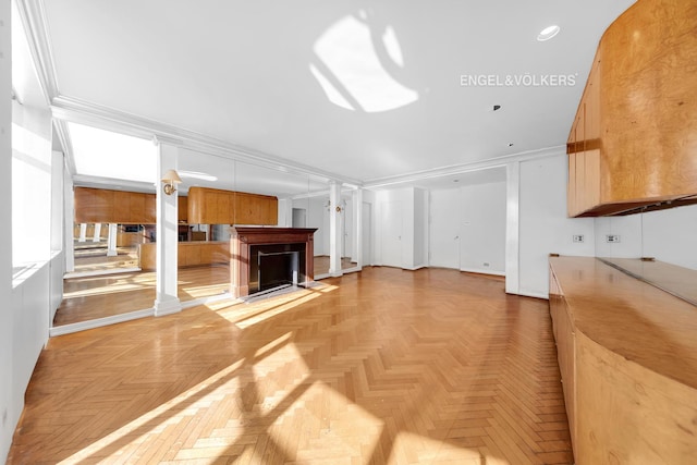 unfurnished living room with crown molding, recessed lighting, ornate columns, and a fireplace