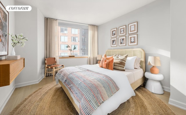 bedroom featuring baseboards and wood finished floors