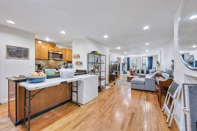 living room featuring light wood-type flooring and recessed lighting