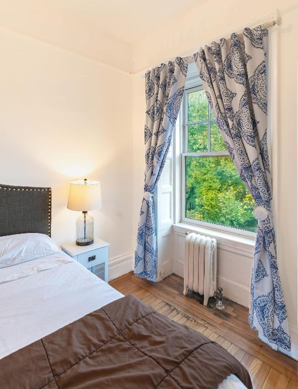 bedroom featuring radiator and light hardwood / wood-style floors