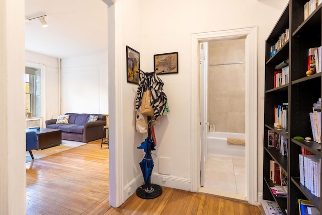 corridor with light hardwood / wood-style flooring