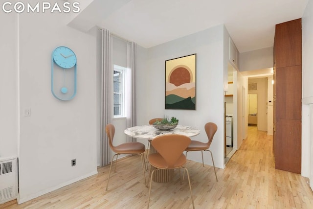 dining space featuring radiator and light hardwood / wood-style flooring