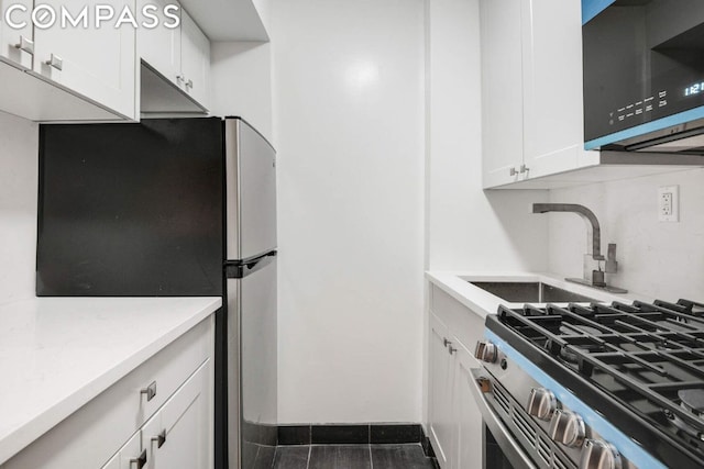 kitchen featuring white cabinets, appliances with stainless steel finishes, and sink