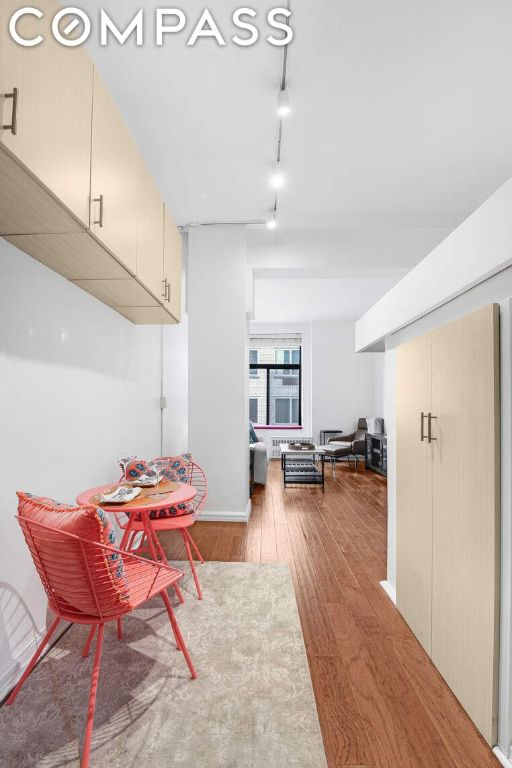 dining room with light hardwood / wood-style floors and rail lighting