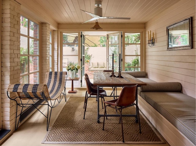 sunroom / solarium featuring wood ceiling and breakfast area