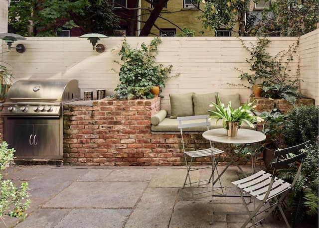 view of patio featuring exterior kitchen and grilling area