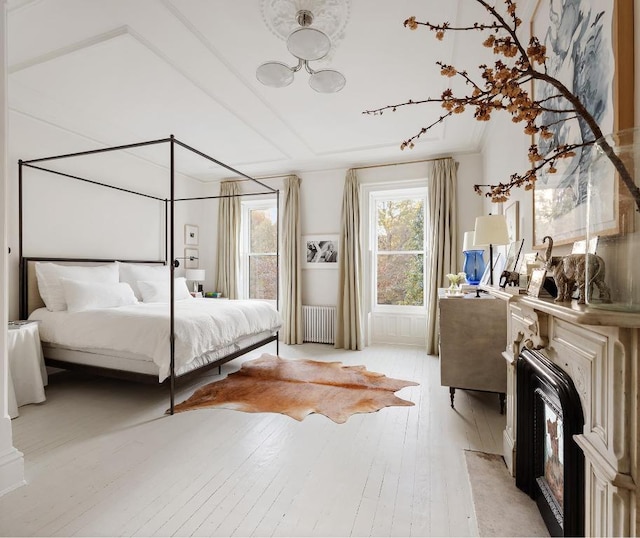 bedroom featuring radiator and light hardwood / wood-style flooring