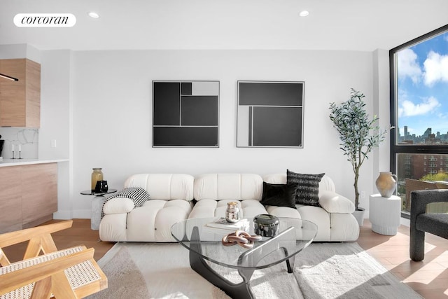 living room featuring floor to ceiling windows and light hardwood / wood-style flooring